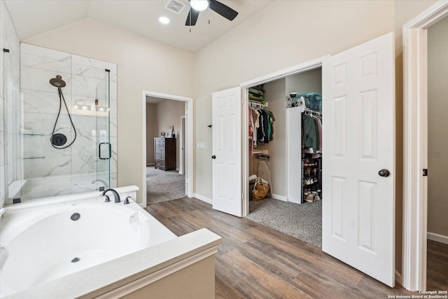 bathroom featuring ceiling fan, hardwood / wood-style floors, vaulted ceiling, and shower with separate bathtub