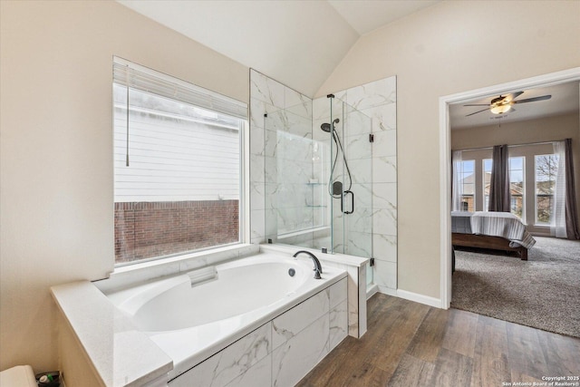 bathroom featuring ceiling fan, separate shower and tub, wood-type flooring, and vaulted ceiling