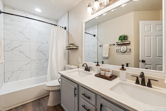 full bathroom with toilet, hardwood / wood-style floors, vanity, and shower / tub combo with curtain