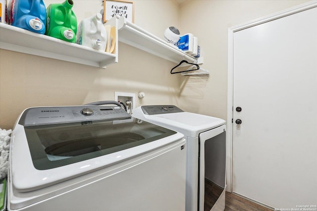 washroom with washing machine and dryer and dark hardwood / wood-style floors