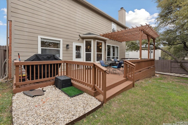 wooden deck with a pergola and area for grilling