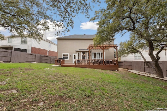 rear view of property featuring a pergola, a wooden deck, and a yard