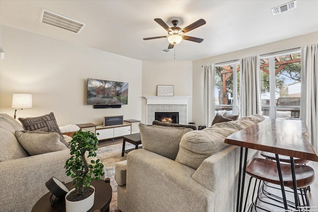 living room featuring hardwood / wood-style floors and ceiling fan