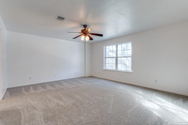 spare room featuring ceiling fan and light colored carpet