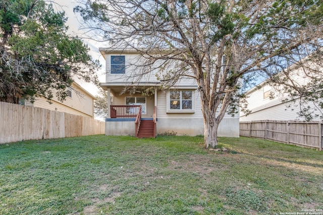 rear view of house with a yard