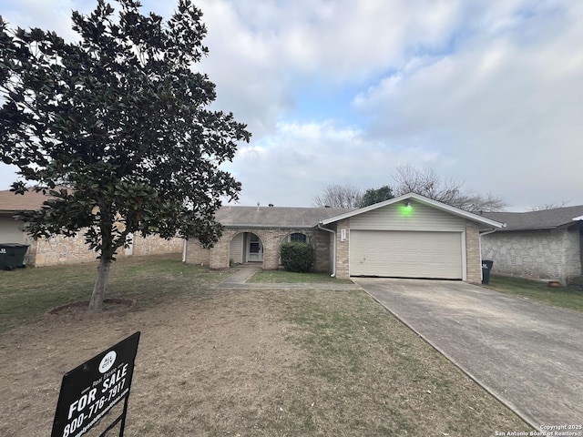 single story home with a front yard and a garage