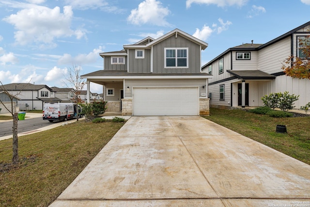 view of front of house featuring a porch, a front yard, and a garage