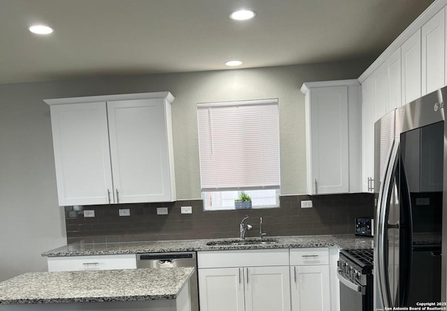 kitchen featuring sink, white cabinetry, and stainless steel appliances