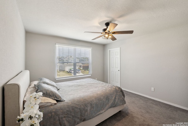 carpeted bedroom featuring ceiling fan and a textured ceiling