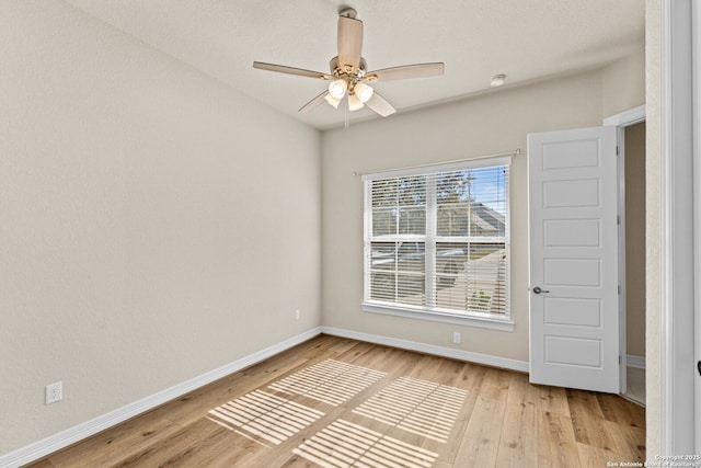 empty room with light hardwood / wood-style floors and ceiling fan