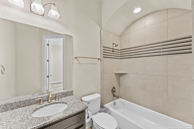 full bathroom featuring toilet, vanity, and tiled shower / bath