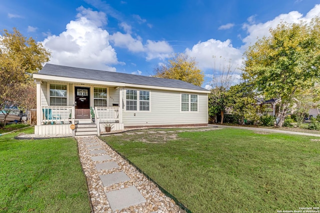 single story home with a porch and a front lawn