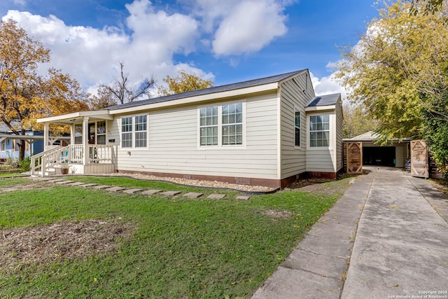 view of front facade featuring a garage, a front lawn, and an outdoor structure