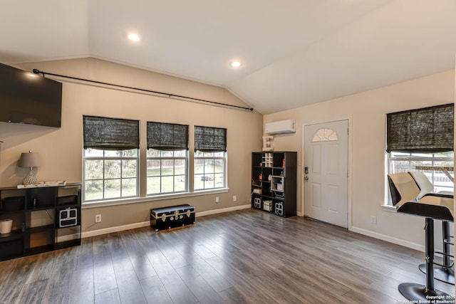 interior space with dark hardwood / wood-style flooring, an AC wall unit, and vaulted ceiling