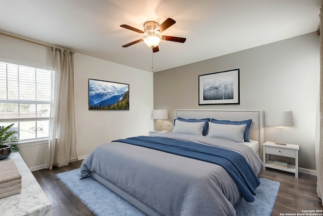 bedroom with multiple windows, ceiling fan, and dark wood-type flooring