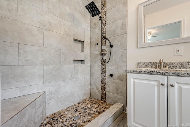 bathroom featuring vanity and tiled shower