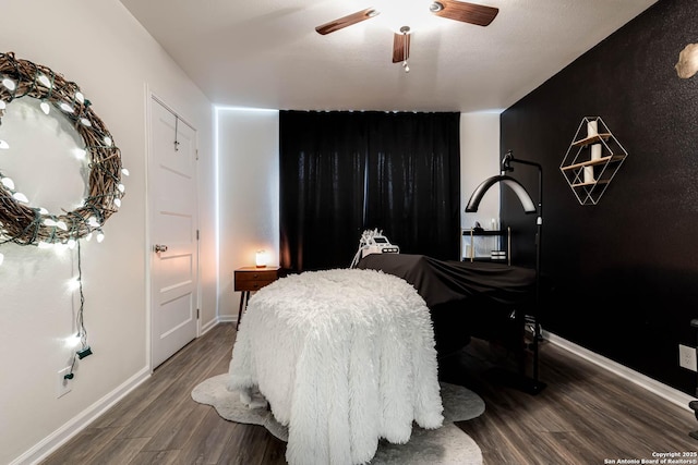 bedroom with ceiling fan and dark wood-type flooring