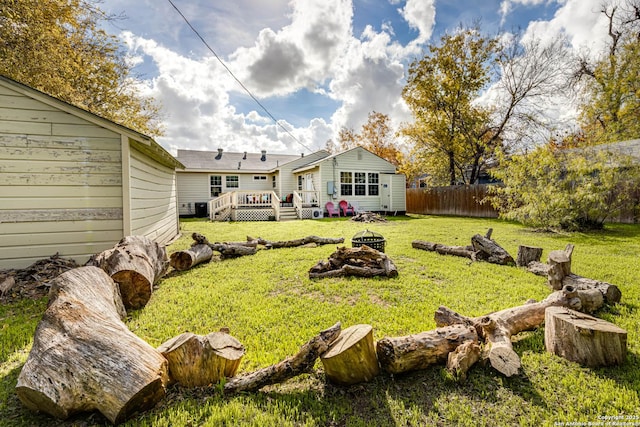 view of yard with a deck and an outdoor fire pit