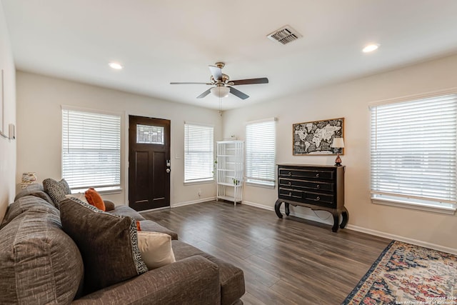 living room with dark hardwood / wood-style floors and ceiling fan