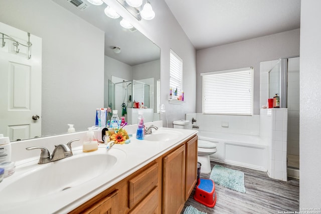 full bathroom featuring wood-type flooring, vanity, toilet, and independent shower and bath