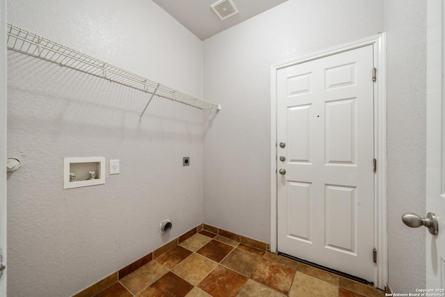 9319 Longmire Trce, San Antonio, TX 78245 - washroom featuring hookup for an electric dryer, washer hookup, dark stone finish flooring, and baseboards