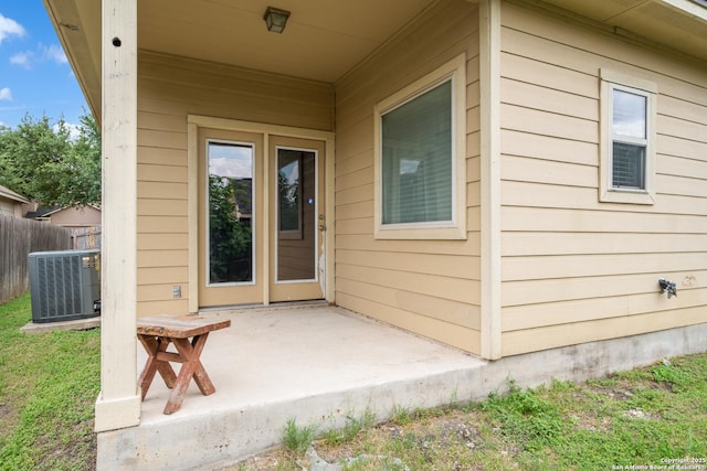 9319 Longmire Trce, San Antonio, TX 78245 - entrance to property with central AC, fence, and a patio