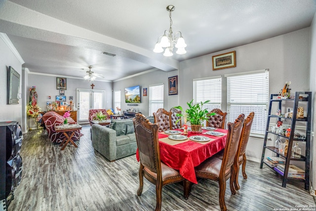 dining area with hardwood / wood-style floors, french doors, ceiling fan with notable chandelier, ornamental molding, and a textured ceiling