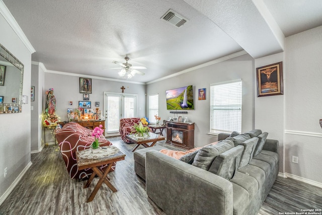 living room featuring crown molding, ceiling fan, and dark wood-type flooring