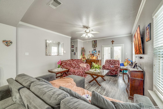 living room featuring crown molding, a textured ceiling, and hardwood / wood-style flooring