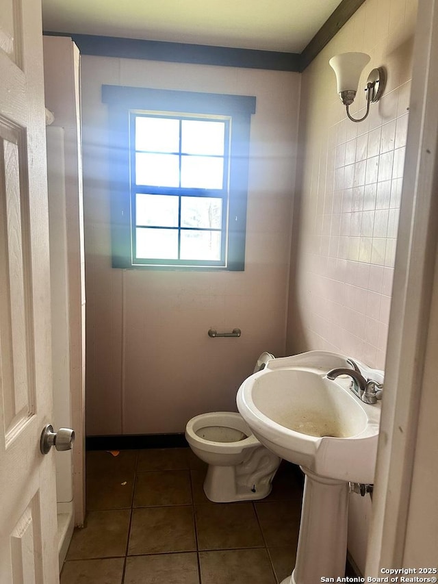 bathroom featuring tile patterned flooring and toilet