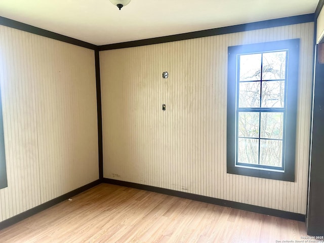 unfurnished room with hardwood / wood-style floors and ornamental molding