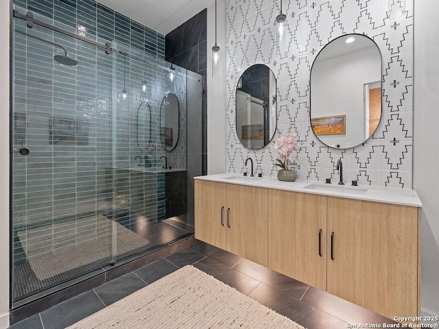 bathroom featuring tile patterned floors, vanity, and a shower with shower door