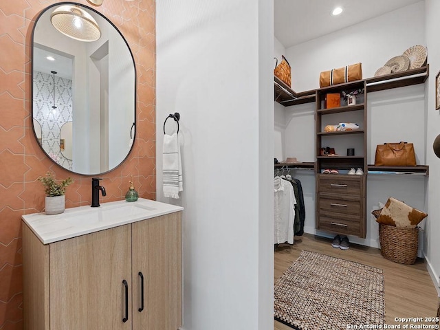 bathroom with hardwood / wood-style floors and vanity