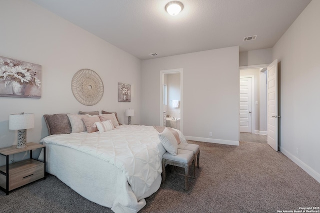 carpeted bedroom with ensuite bath