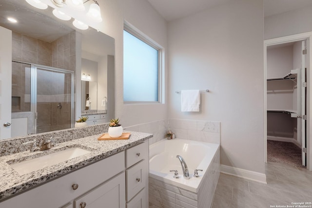 bathroom with tile patterned flooring, vanity, and independent shower and bath