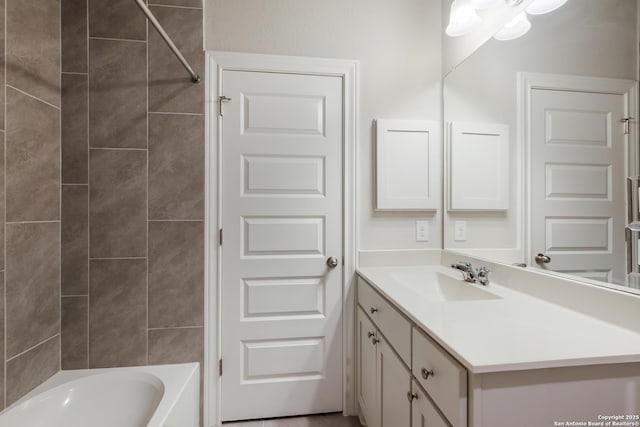 bathroom with vanity and tiled shower / bath combo