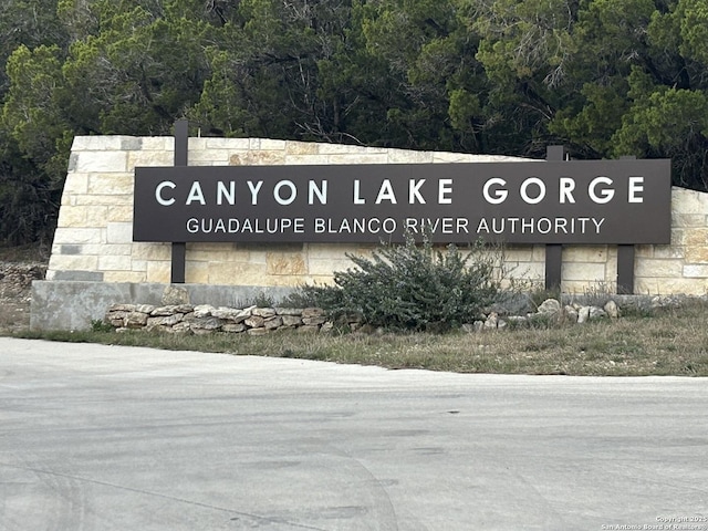 community sign with a wooded view