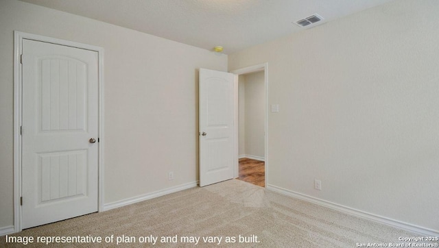 unfurnished bedroom with light colored carpet