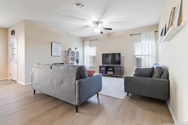 living room featuring ceiling fan and light hardwood / wood-style floors