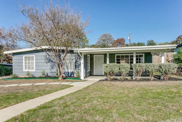 ranch-style home with a porch and a front yard