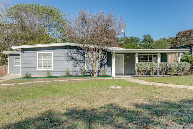 single story home featuring a front lawn