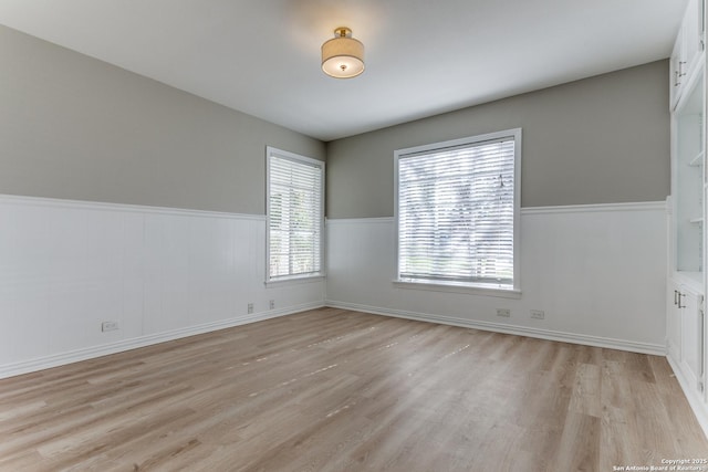 spare room with light hardwood / wood-style floors