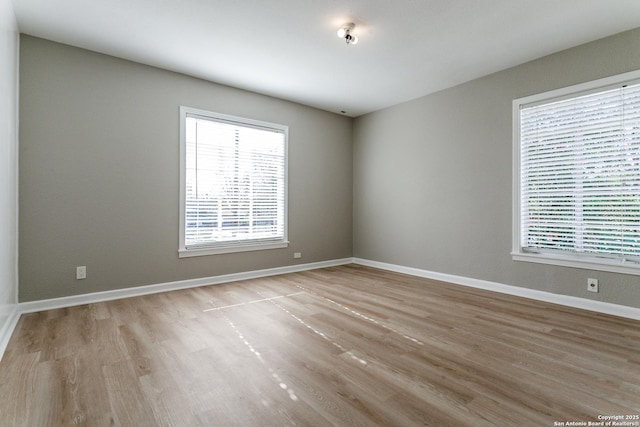 spare room with light hardwood / wood-style flooring