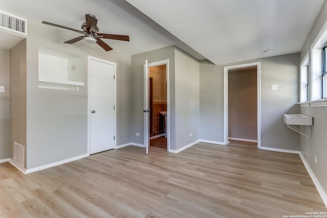 spare room with light wood-type flooring and ceiling fan