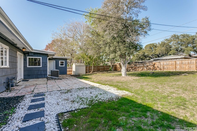 view of yard featuring cooling unit, a patio, and a storage unit