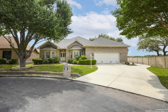 ranch-style house featuring a garage and a front lawn