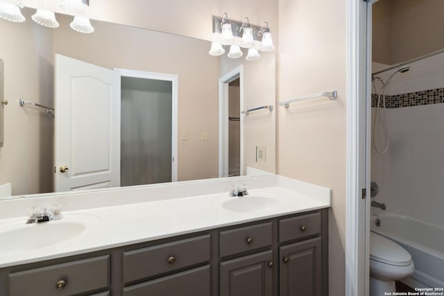 full bathroom featuring vanity, toilet, and tiled shower / bath