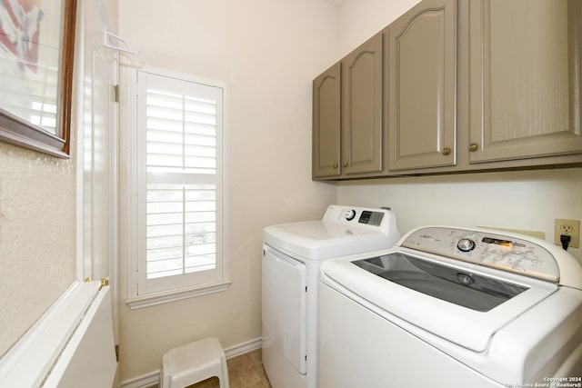 laundry area featuring tile patterned flooring, cabinets, and independent washer and dryer