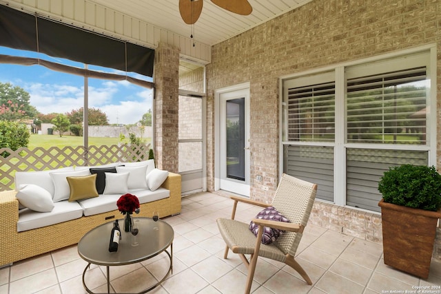 sunroom / solarium featuring ceiling fan