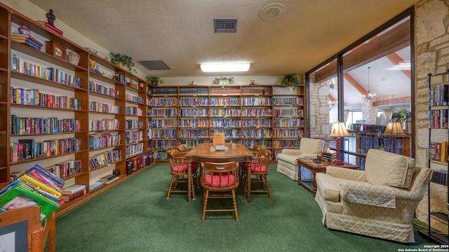 living area with carpet, a textured ceiling, and a chandelier